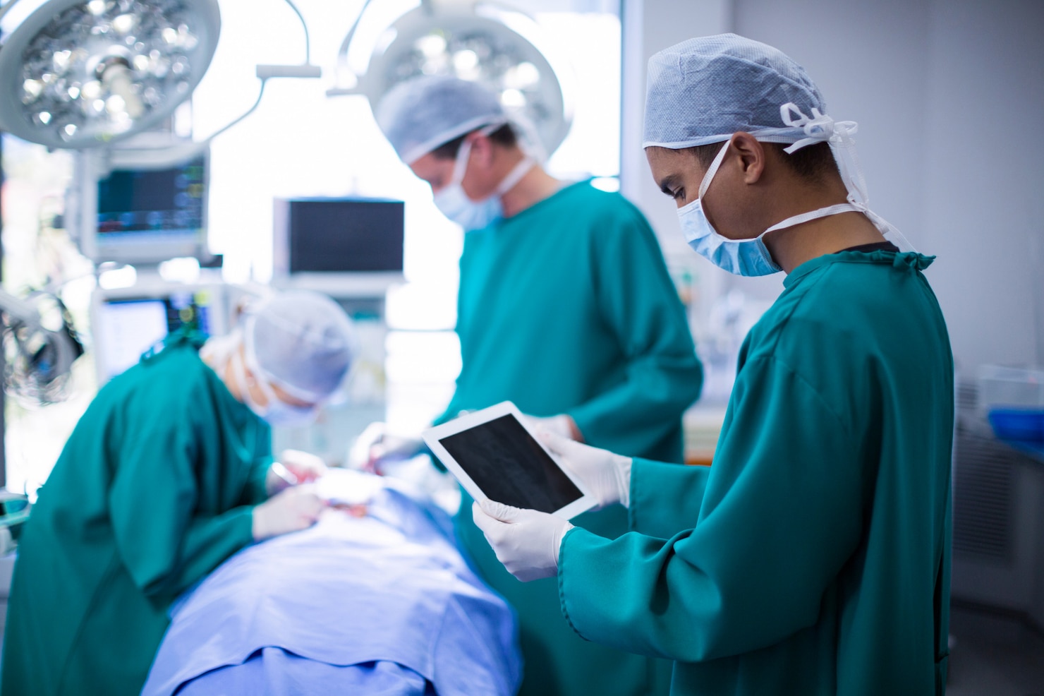 Surgeon using digital tablet in operation theatre